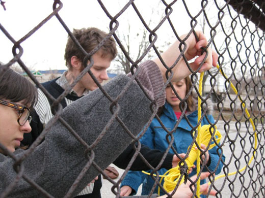 Danielle, Michelle, and Steven measure some of the rope on the fence