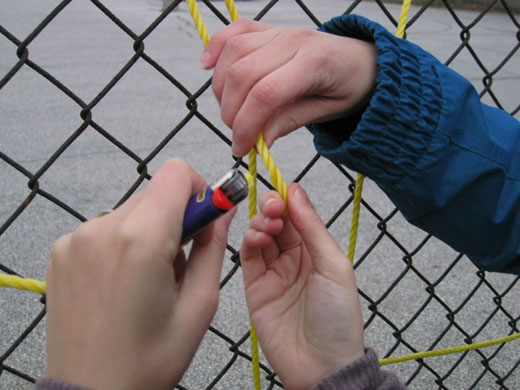 Michelle and Danielle begin attempting to use the lighter instead of knots