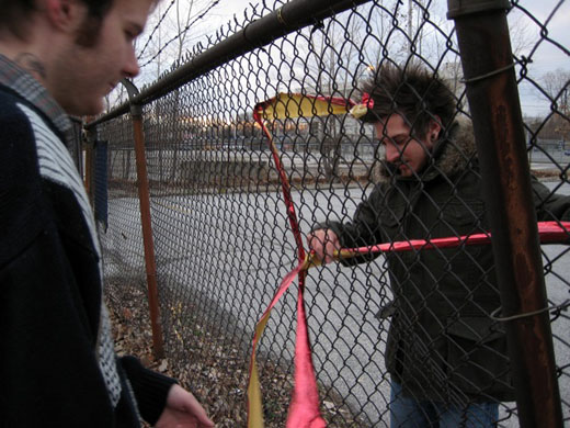 Steven and Justin work on ribbon with the fence
