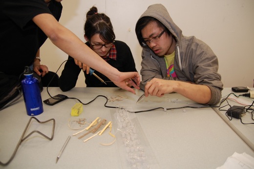 Josh, Danielle, and Immony working on soldering