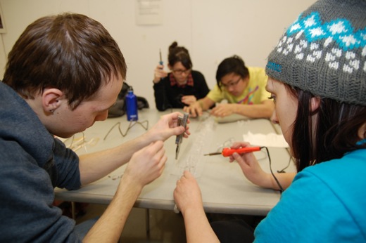 Josh, Michelle, Danielle and Immony soldering the sign