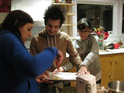 It takes three of us to hold down the parchment paper, hold the baking sheet, and carefully put on some fortune cookie dough