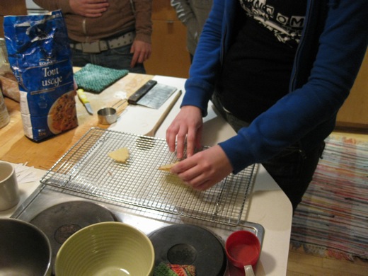 after waiting for one to cool, Michelle begins the folding process