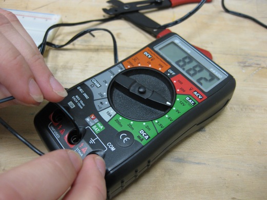 using the multimeter to make sure we were getting around 9v from the power adapter