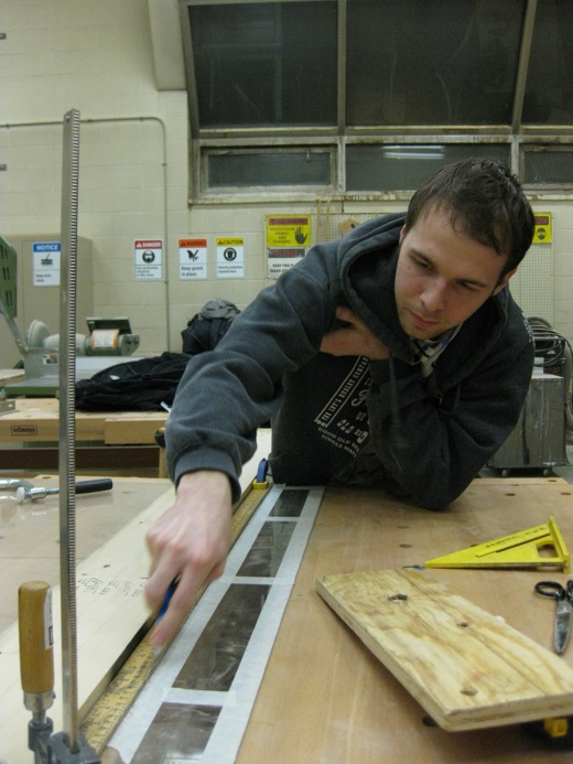 Josh begins scoring the plexiglass