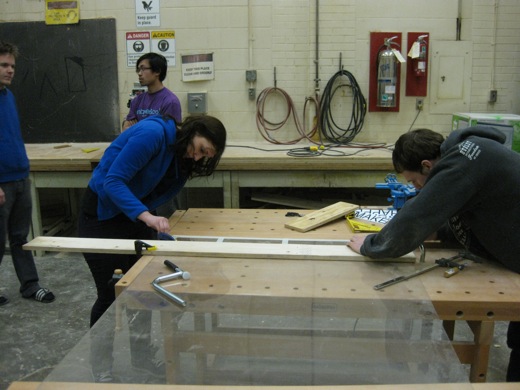 Michelle and Josh work to finish scoring the plexiglass