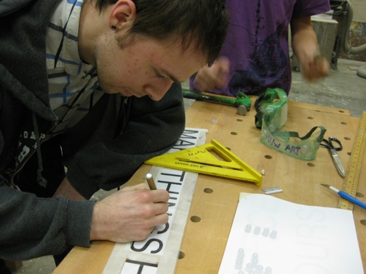 Josh begins marking where the holes need to go for the LEDs