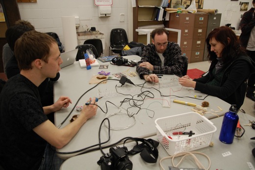 back around the table, continuing to work on the LED sign