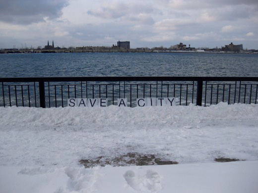 SAVE A CITY, installed at the Windsor river front, facing Detroit